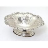 A silver bonbon dish with C-scroll and foliate decoration raised on oval stepped base. Hallmarked