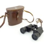 A cased pair of Dollond, London 9 x 35 binoculars / field glasses, with lens caps and strap, the
