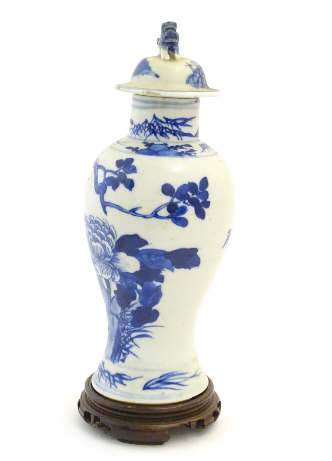 A Chinese blue and white vase and cover with floral, foliate and bird detail. The lid with foo dog - Image 3 of 7