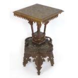 A late 19thC / early 20thC Moorish table with mother of pearl inlays, carved detailing and