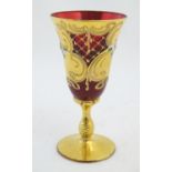 A ruby glass goblet with gilt and enamel overlay. Approx. 7" high Please Note - we do not make