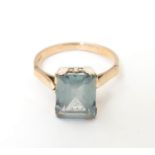 A 14ct gold ring set with baguette coloured blue stone. Ring size approx K Please Note - we do not