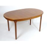 Vintage retro, mid-century: a teak oval extending dining table by McIntosh of Kirkaldy, with