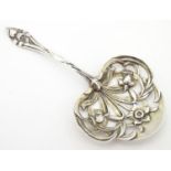 An American silver Art Nouveau straining spoon with floral tendril detail, maker Gorham . Approx 4