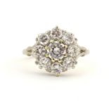 An 18ct white gold diamond cluster ring, the central diamond approx. 0.7ct bordered by 8 brilliant