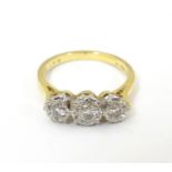 An 18ct gold ring set with trio of diamonds. ring size approx K. Please Note - we do not make