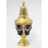 A silver gilt caster with swag detail and blue glass liner. Marked with importers mark for John