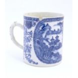 A Chinese blue and white export mug depicting a landscape scene with pagodas, with floral and