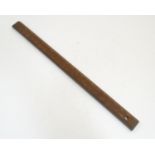 A Victorian rule / ruler with brass mounts, maker I Aston, London. 24" long Please Note - we do