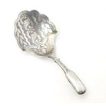 A Geo III silver caddy spoon, the shaped bowl with engraved floral decoration. Hallmarked Birmingham