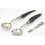 Two silver plate strainer spoons with antler handles, together with a miniature white metal fork.