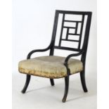 A late 19thC Aesthetic movement nursing chair in the manner of E.W Godwin with an ebonised finish