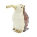 A studio pottery model of a bird with an elongated beak. Impressed marks above feet. Approx. 6 1/