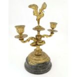 A 19thC ormolu candelabrum on a turned marble base surmounted by a stork bird. Approx. 11 1/4" high.