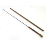 A 19thC swordstick walking cane, the bamboo shank concealing a 22 5/8" triform dispatching blade.