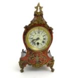 A 19thC French Boulle style mantel clock, the enamel dial with numerals encircled by minute markers,