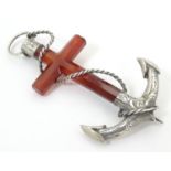 A Victorian brooch formed as an anchor set with carnelian and white metal detail. 3" high Please