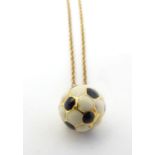 A novelty pendant / charm formed as a football with enamel decoration. on a 9ct gold chain Approx