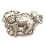 An oriental white metal decorative mount formed as a Chinese lion dog / Shishi. 1 3/4" long Please