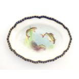 A Royal Worcester dish of oval form with a lobed rim with fish detail. Marked under. Approx. 5 1/