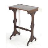 A mid 19thC mahogany side table with a rectangular to above scrolled supports and a shaped