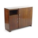 An Art Deco period teak sideboard, of rectangular form with curved corner, opposing doors concealing