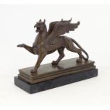 A 20thC cast model of a griffin with the body of a lion and the head and wings of an eagle. After