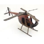 A 20thC wood and steel model of a helicopter and pilot with polychrome decoration. Approx. 11 1/4" x