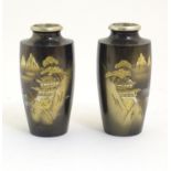 A pair of Oriental vases with chokin style engravings depicting a mountain landscape scene with a