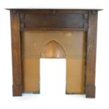 An early 20thC oak and copper fire surround. 56" wide x 53" high. Please Note - we do not make