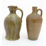 A studio pottery jug with drip glaze, together with a stoneware wine flagon with impressed marks
