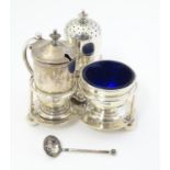 A Victorian silver three piece cruet set on stand, the stand raised on three ball feet and with loop