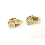 A pair of 9ct gold stud earrings set with white stones Please Note - we do not make reference to the