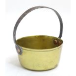 A 19thC small brass caramel pan, with fixed cast iron handle, 5 5/8" wide, 6" tall Please Note -