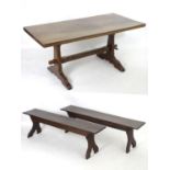 A mid 20thC dining table and two benches by Jack Grimble of Cromer. Having adzed tops and frames