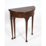 An early 18thC and later mahogany demi lune gate leg table, with a two fold table and raised on