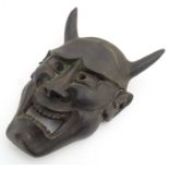 A Japanese carved wooden Noh mask modelled as the female demon Hannya. Approx. 17" high Please