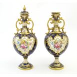 Two Royal Doulton pedestal vases with cobalt blue ground, gilt highlights and hand painted floral