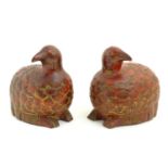 A pair of Oriental red lacquered carved wooden models of quail birds the feathers with gilt