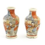 A pair of Japanese Satsuma vases of small proportion decorated with stylised figures. Character