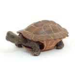 A Chinese Yixing clay model of a tortoise with an articulated head. Impressed character marks under.