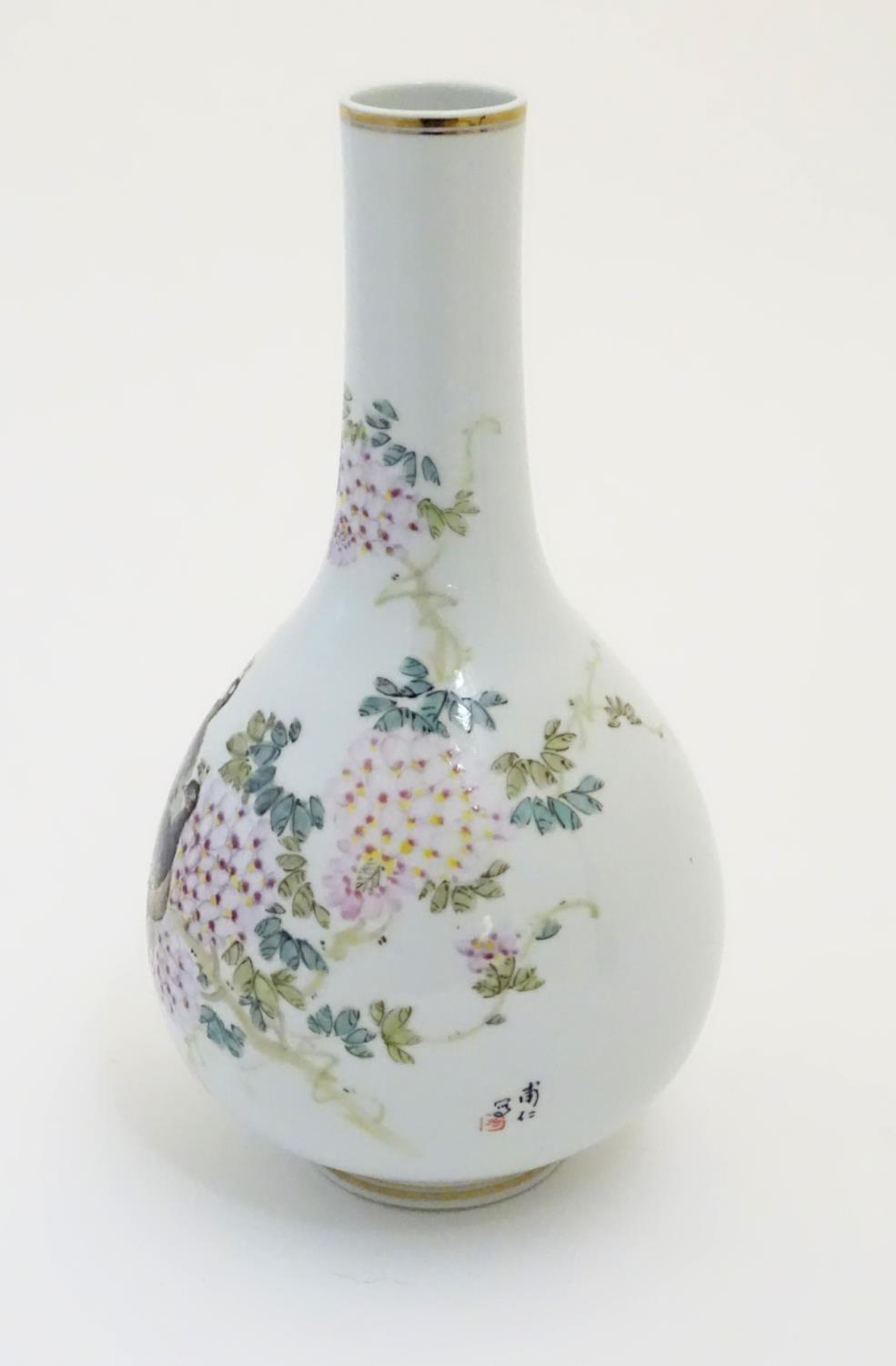 A Chinese globular vase with an elongated neck decorated with peacocks and flowers in a landscape, - Image 3 of 6