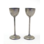 A pair of 20thC metalware stemmed goblets of small proportion. Impressed bird mark under. Approx.