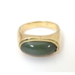 A 14ct gold ring set with jade cabochon. Ring size approx. P 1/2 Please Note - we do not make
