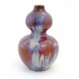 A Chinese double gourd vase with a high fired glaze. Approx. 13 1/2" high Please Note - we do not