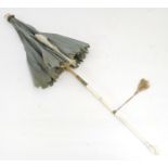 A 19thC folding parasol with a carved ivory handle. Approx. 27 1/4" Please Note - we do not make