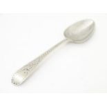 A George III silver teaspoon with bright cut decoration, hallmarked London 1797.4 1/2" long Please