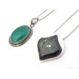 A silver pedant and chain the pendant set with malachite coloured cabochon. The pendant 1 3/4" long.