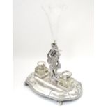 A silver plate standish with central epergne flute supported by cast figure of St George slaying the