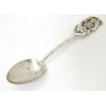 An Oriental white metal teaspoon with stylised bamboo handle surmounted by bat decoration. Marked